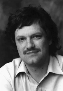 Black and white studio portrait of Hans-Werner Braun, dark-haired and moustached, in an open-necked shirt.