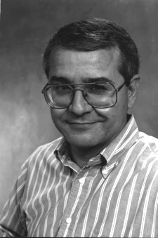 Black and white portrait of Rick Boivie in glasses and a striped shirt.